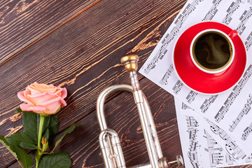 Trumpet, musical notes and cup. Classical music background. Music still life.