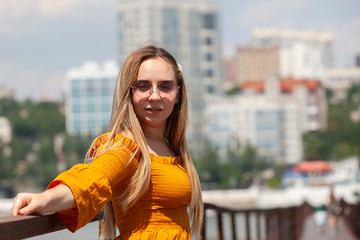 Fototapeta premium Blonde woman looking at camera. Blonde woman with thick eyebrows and blue eyes.