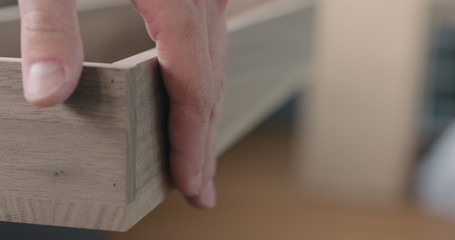 woodworker checking black walnut drawer tray
