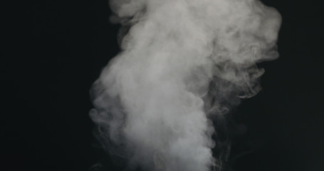 water vapor stream comes from below over black background with motion blur