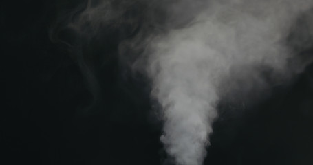 water vapor stream comes from below over black background with motion blur