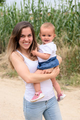 Fototapeta premium happy mother and smiling with her daughter in the street