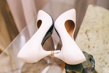 Wedding shoes gold rings on a beautiful background. wedding ceremony gathering bride and groom. two mr and mrs