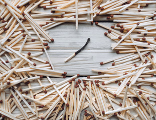 A lot of matches on a wooden background. Concept and photography. Extinguished fire. The revolution in the modern world.