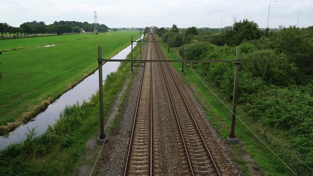 Dutch Sprinter train passes in high speed between Hilversum and Utrecht on a sunny day