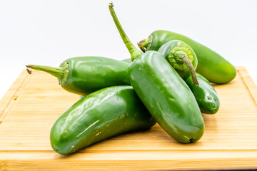 Jalapeno peppers on a wooden cutting board. Calgary, Alberta, Canada