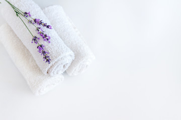 white clean towels and lavender flowers on white isolated background