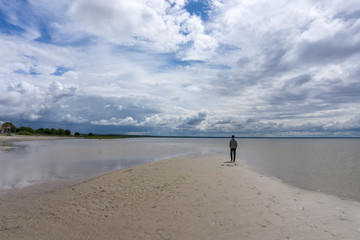 A lonely boy walking on the beach. Pärnu. Latvia