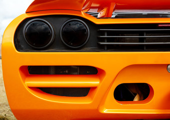 Car rear lights with orange of sport sedan bodywork closeup