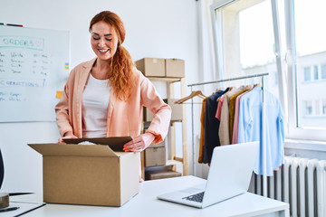 Small business owner packing sold items and preparing deliveries