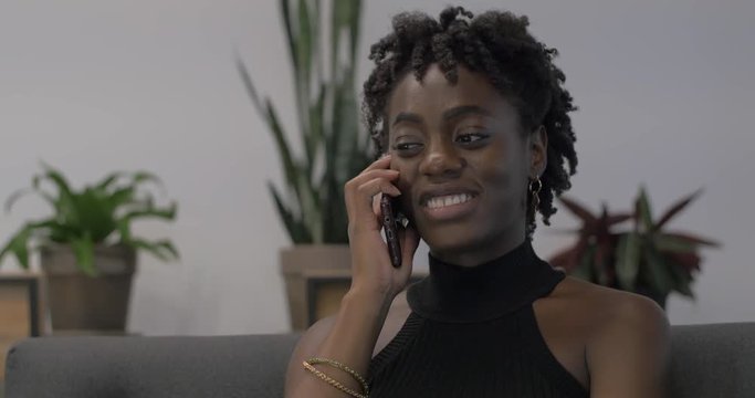 Close up of African American Woman Talking to Friends on Phone