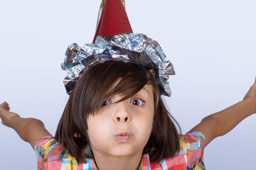 Little boy wearing a party hat.