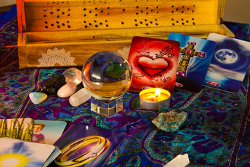 Tarot cards and crystal ball at candle light