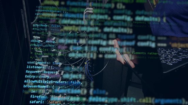 A person works with a laptop, programming a code.