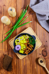 Roast potatoes with chanterelles and onions in a cast iron pan. Traditional dish of russian cuisine.