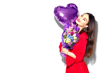 Valentine's Day. Beauty girl with colorful bouquet of flowers and heart shape air balloon on white background. Beautiful happy young woman