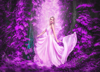 Beauty romantic young woman in long chiffon dress with gown posing in fantasy misty forest....