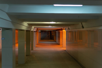 Underpass under the street in the city. Empty underpass with poor lighting.
