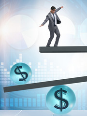 Businessman balancing in financial dollar concept