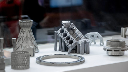 Man is holding object printed on metal 3d printer.