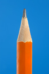 Close up of yellow pencil tip on blue background