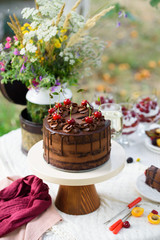 Delicious chocolate cake, red velvet in a glass, wild flowers, berries.