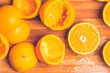 Orange background. Closeup of half cut and squeezed fruits in pattern next to each other