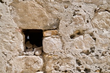 Beige wall background, one brick missing