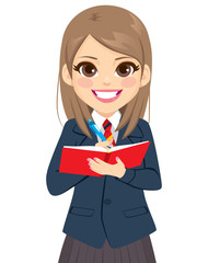 Young student girl in school uniform standing writing on notebook book