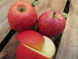 Red apples on wooden table