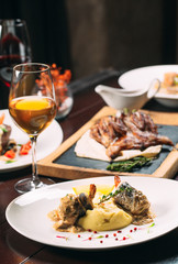 Grilled partridge, sea bass, Tartarus.  Different dishes on the table in the restaurant.