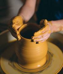 Pottery workshop. A little girl makes a vase of clay. Clay modeling