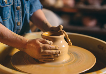 Pottery workshop. A little girl makes a vase of clay. Clay modeling