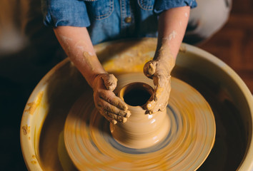 Pottery workshop. A little girl makes a vase of clay. Clay modeling