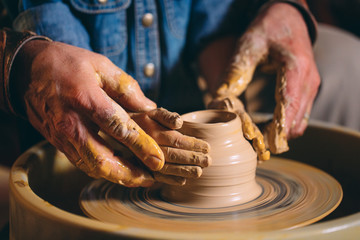 Pottery workshop. A little girl makes a vase of clay. Clay modeling
