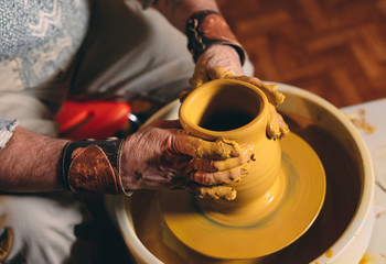 Pottery workshop. A senior man makes a vase of clay. Clay modeling