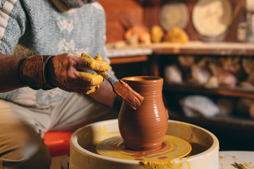 Pottery workshop. A senior man makes a vase of clay. Clay modeling
