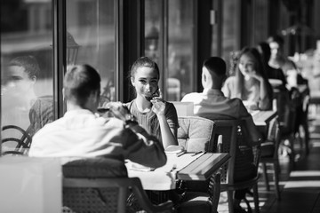 A young couple drinking wine in a restaurant near the window.