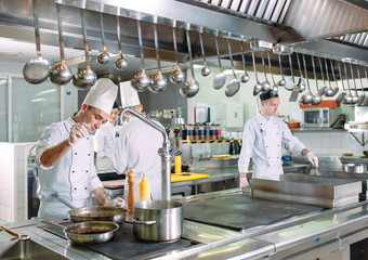 Modern kitchen. The chefs prepare meals in the restaurant's kitchen.