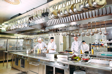 Modern kitchen. The chefs prepare meals in the restaurant's kitchen.