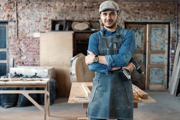 Successful handsome businessman with stylish cap work in carpentry