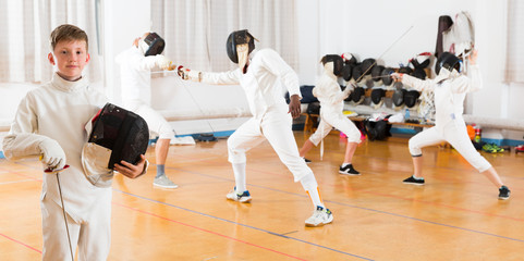 young fencer posing with rapies