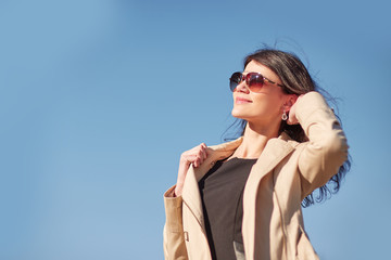 portrait of a young successful woman against the sky