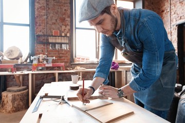 Successful handsome businessman with stylish cap work in carpentry