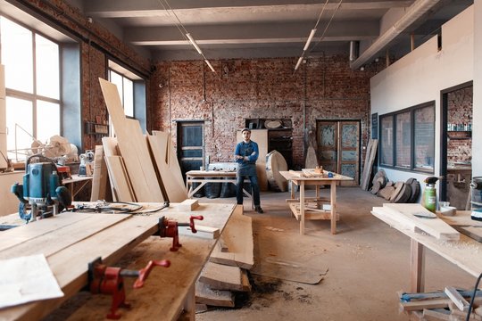 Successful handsome businessman with stylish cap work in carpentry