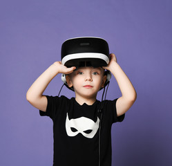 Young boy kid child play virtual reality game wear vr glasses and explore alternative reality. Cyber space and virtual gaming