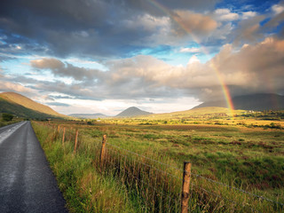 Colorful rainbow in a green field, Beautiful rich sky, Connemara loop, Ireland.