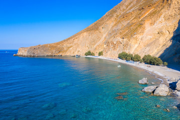 Fototapeta na wymiar Aerial view of Glyka Nera beach (Sweet Water or Fresh Water). View of the remote and famous Sweet Water Beach in south Crete, with its unique tavern on the rock inside sea. This is a nudist beach.