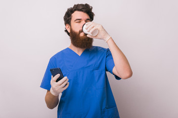 Portrait of young doctor drinking his coffee