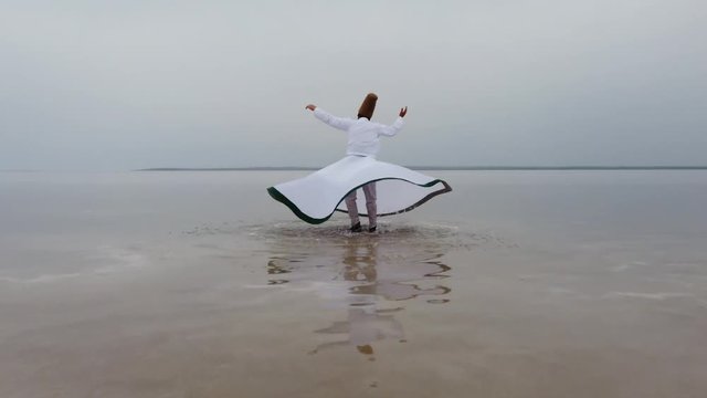 sunset and whirling at the sea, sufi. sufi whirling (Turkish: Semazen) is a form of Sama or physically active meditation which originated among Sufis. 4k